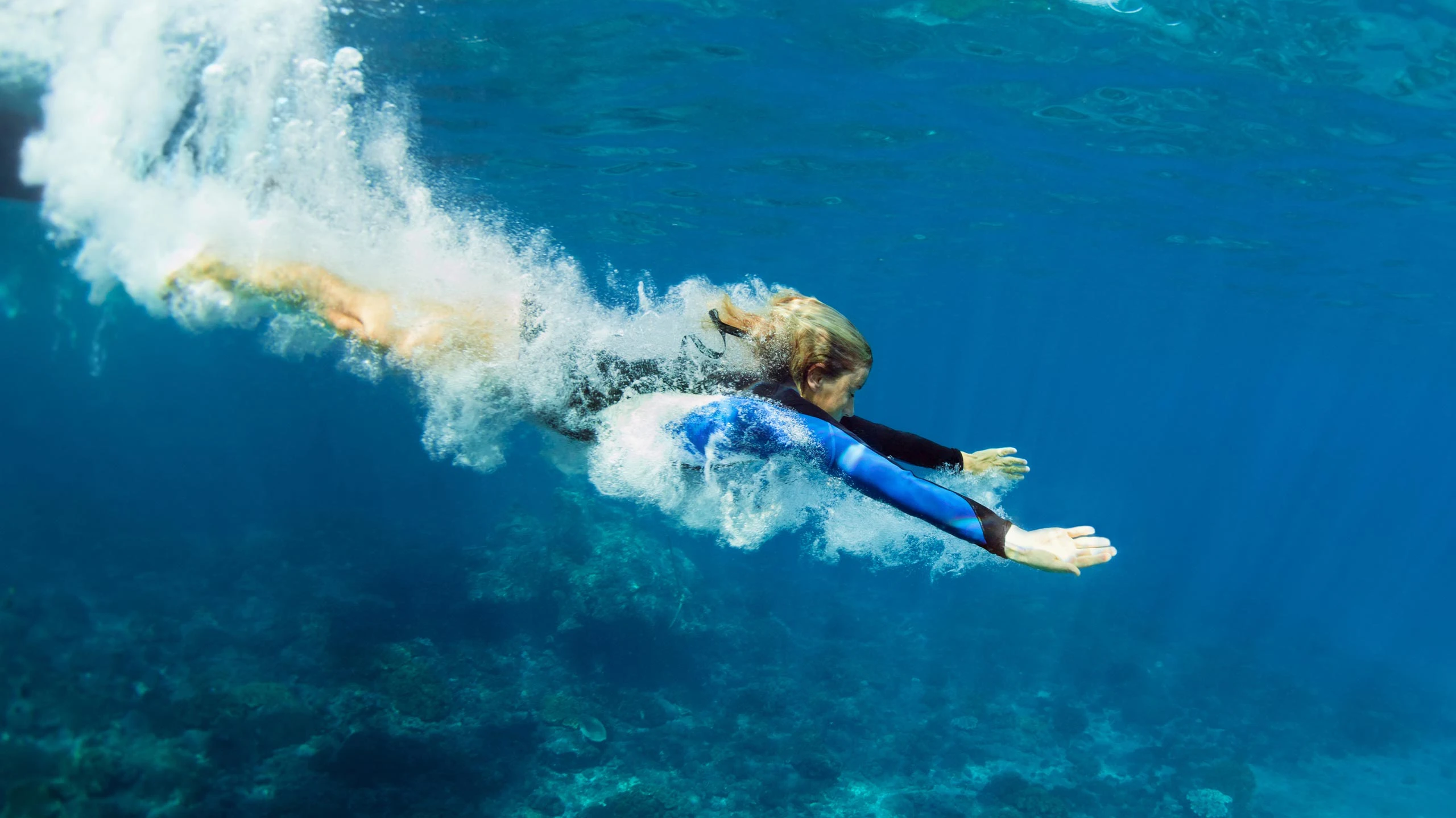 Teenager diving on family holiday