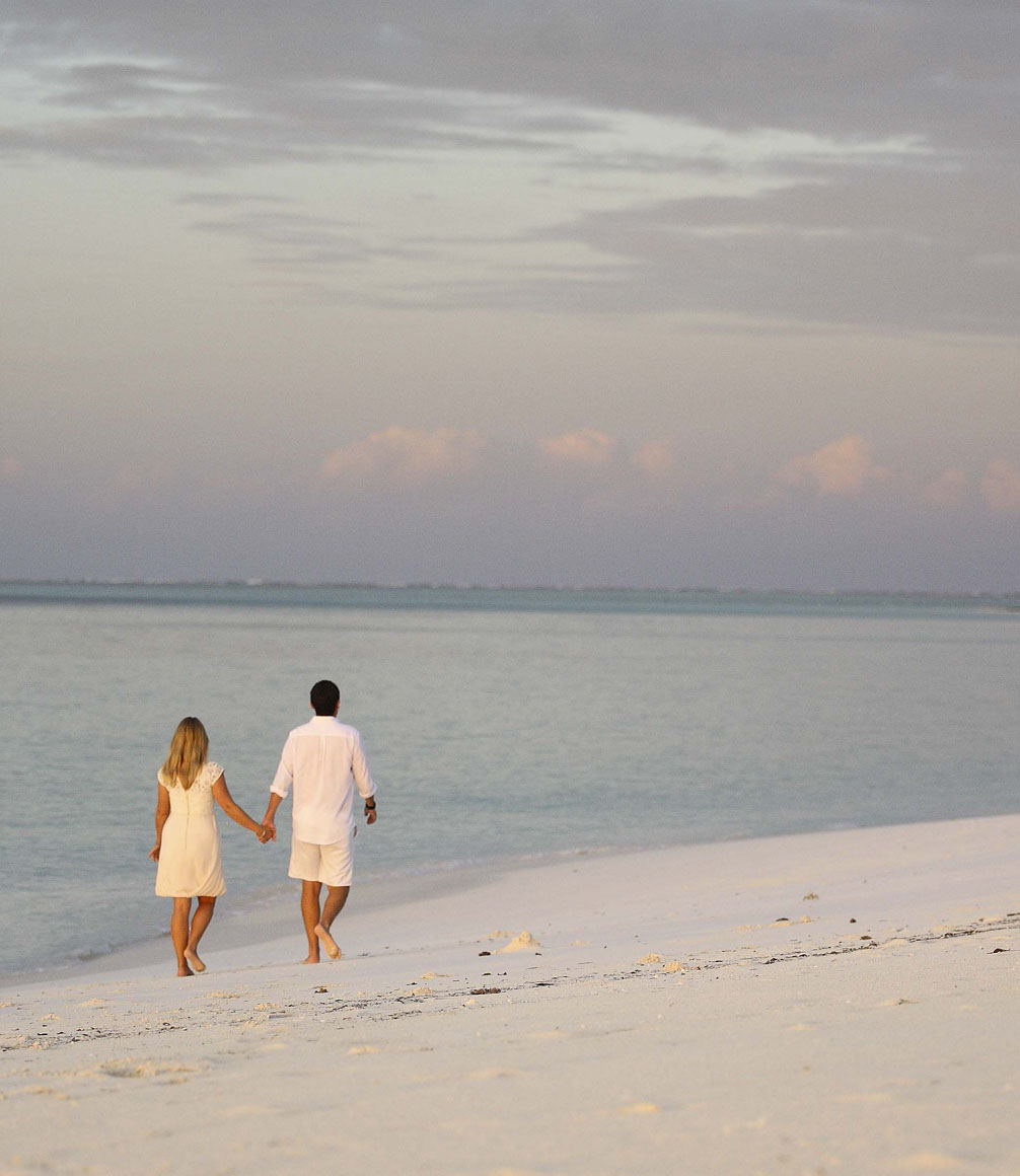 mnemba island couple walking on beach