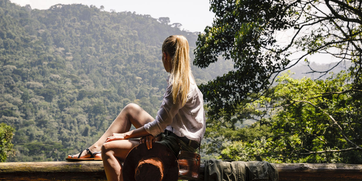 Woman overlooking Bwindi Forest at Sanctuary Gorilla Forest Camp