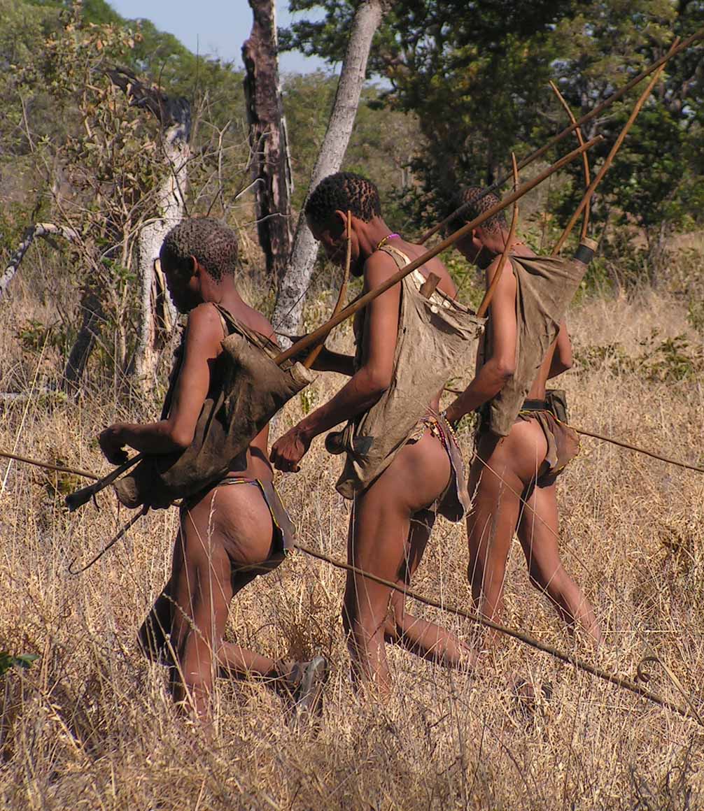 Men from the Nhoma tribe in Namibia walking in the bush