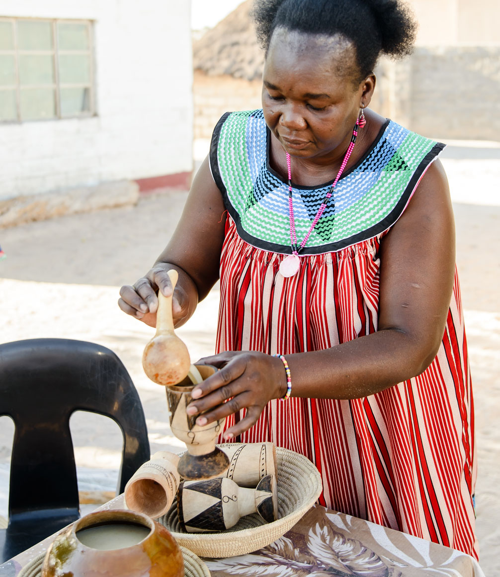 Ovambo woman in namibia demonstrating traditional tribal skills