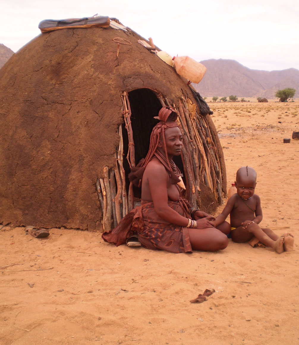 OvaHimba woman and child outside their hut in northern Namibia