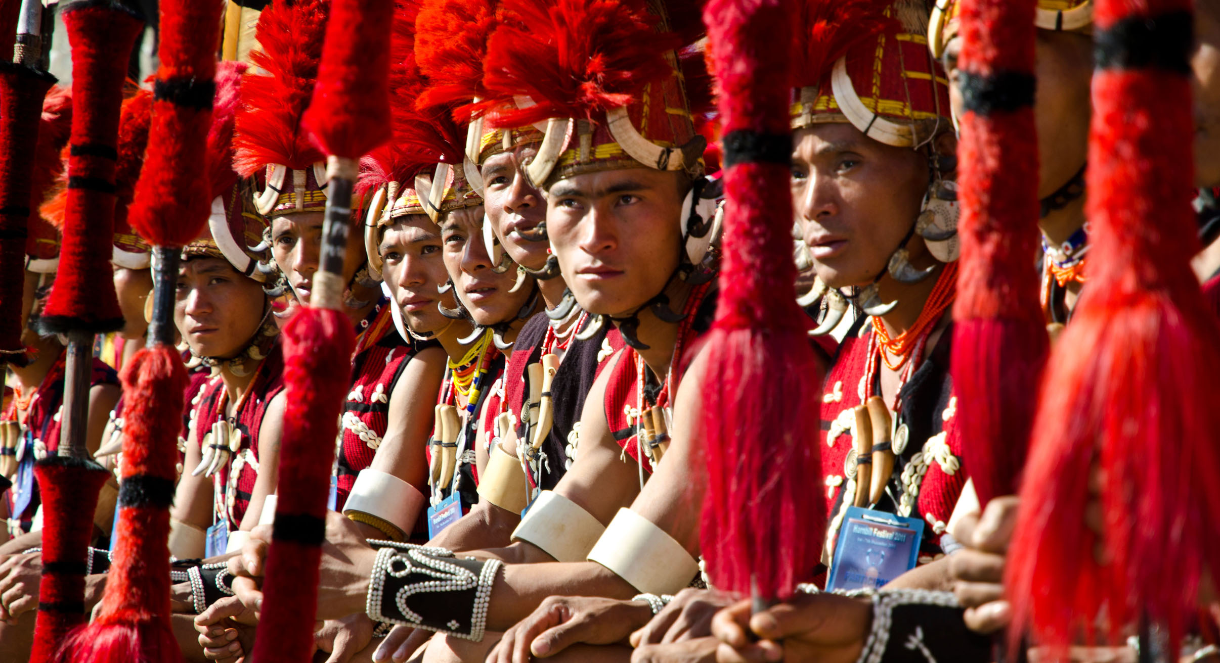 Warriors of the Yimchunger tribe waiting to perform ritual dances at the Hornbill Festival, Kohima, Nagaland, India, Asia