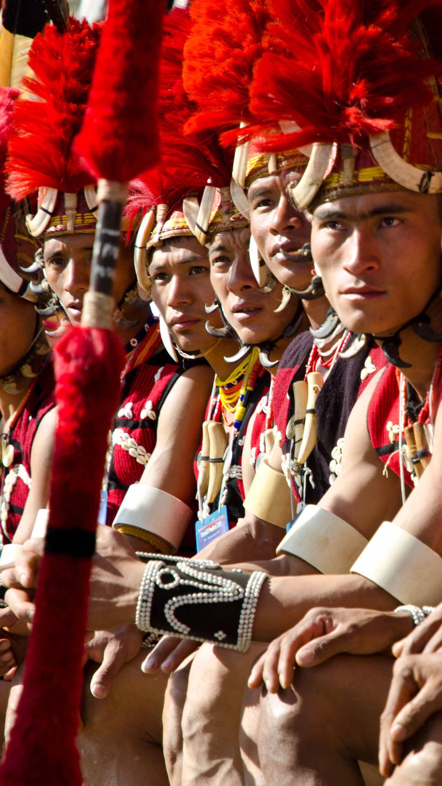 Warriors of the Yimchunger tribe waiting to perform ritual dances at the Hornbill Festival, Kohima, Nagaland, India, Asia