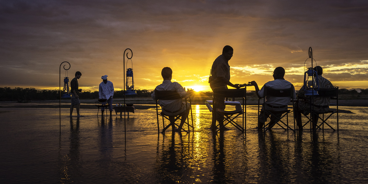 sundowners in the river on a walking safari in south luangwa